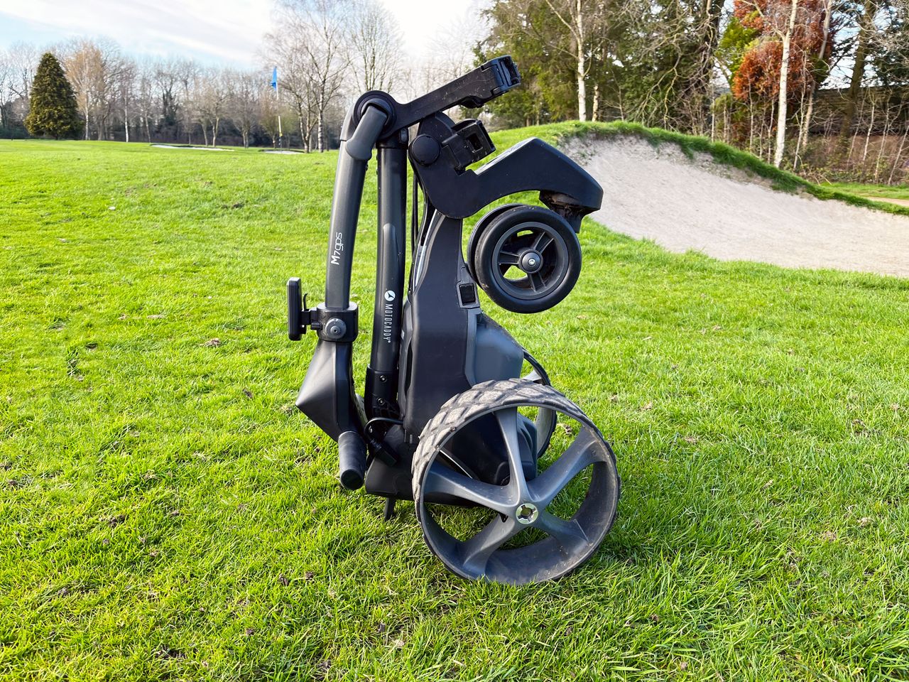 The Motocaddy M7 GPS folded up and standing