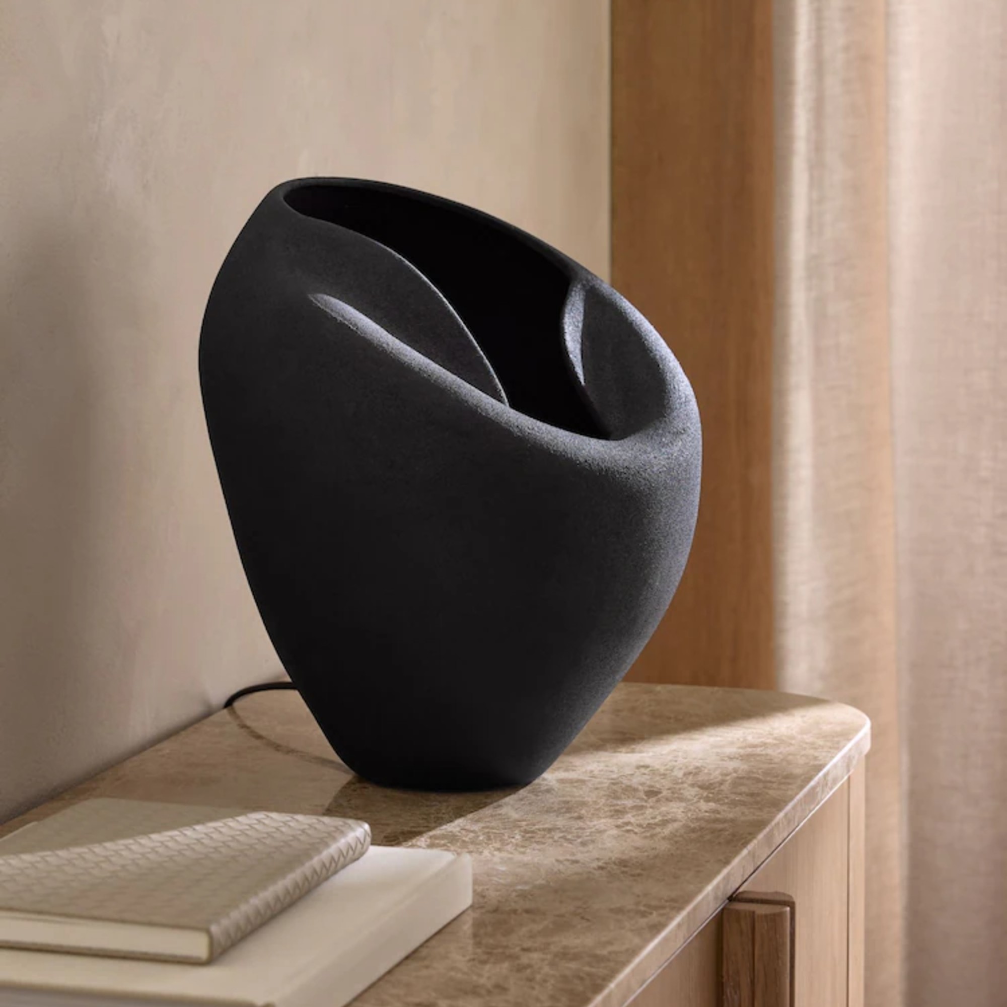 Next N. Premium Isac table lamp in black on a console table