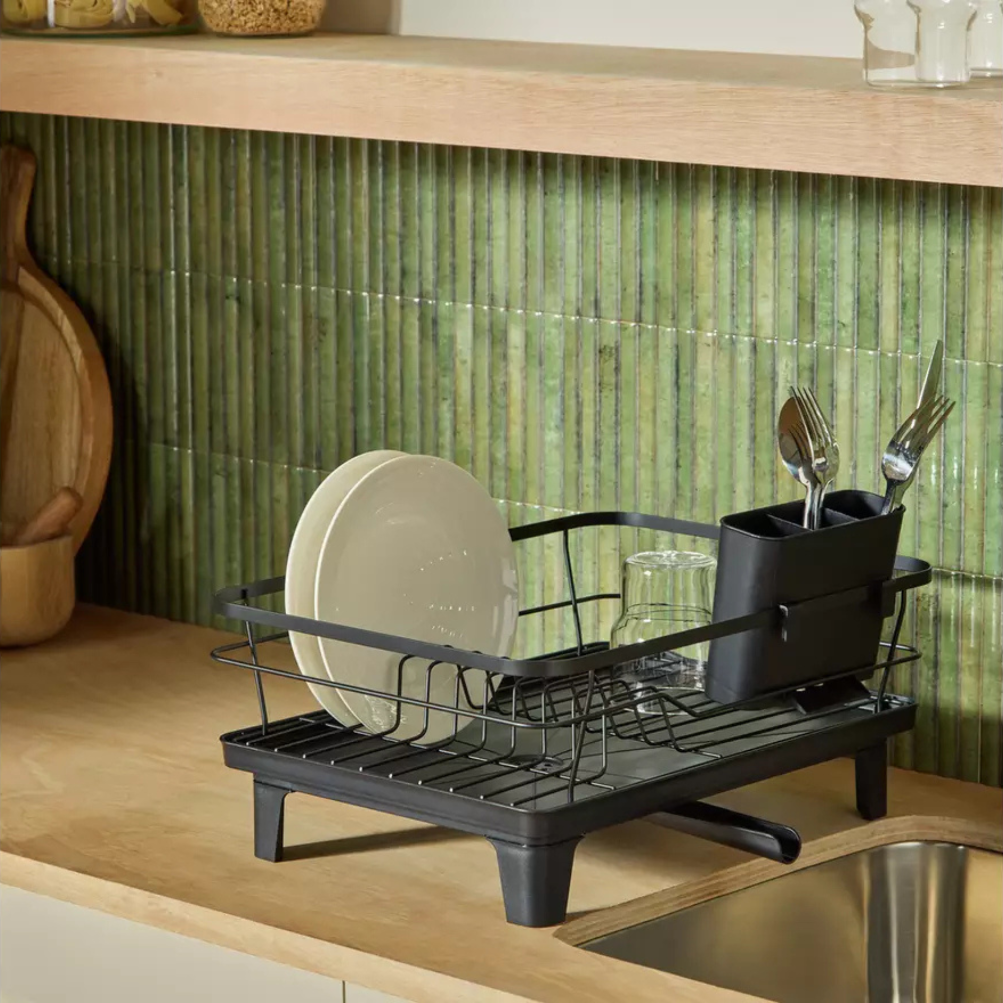 Argos black draner in a kitchen. There are green vertical tiles and a wooden worktop.