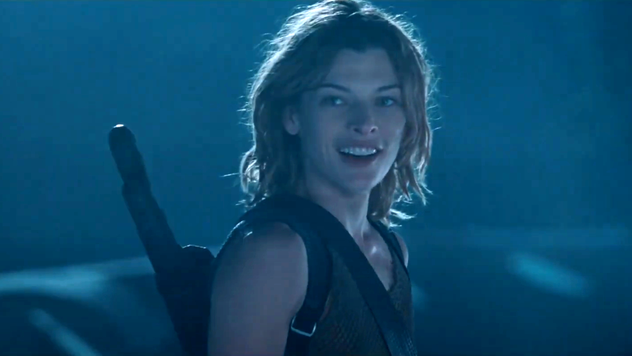 Milla Jovovich looks back and smiles in a night scene in Resident Evil Apocalypse.