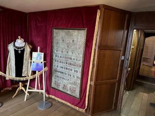 The wardrobes sub-divide the bedroom from a pink bathroom and the room currently has a gown worn by Anne Boleyn on display inside