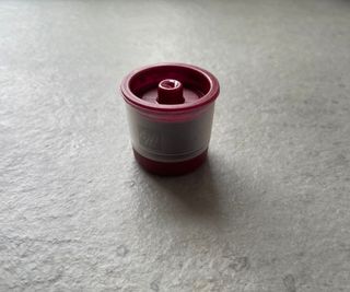 illy x7 coffee capsule on a grey countertop