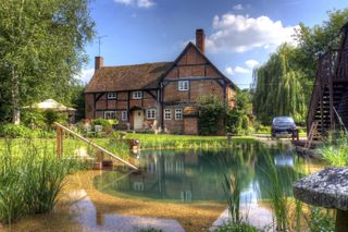 natural swimming pool in the large garden of a traditional cottage