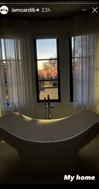 picture of freestanding bathtub by windows in cardi b's home