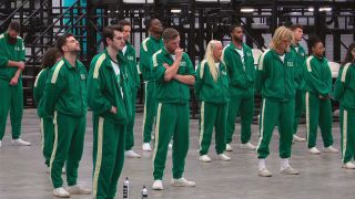 Groups of competitors in green jumpsuits. 