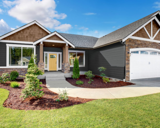 Modern home painted in Behr's Dark Ash, with all trim and garage door in Whisper White, and front door in Charismatic, Shingles, porch ceiling and columns in Tugboat stain