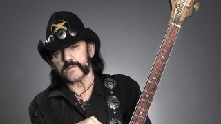 Lemmy holding his bass guitar - studio portrait
