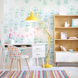 children room with tabletop desk lamp and wooden open shelve