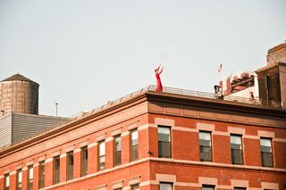 View of a single dancer on the corner of a rooftop