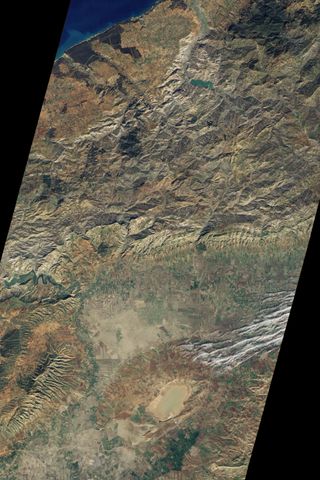 While most of Algeria is desert, along the Mediterranean coast, hills and mountains abound. On Dec. 17, 2010 the Advanced Land Imager (ALI) on NASA's Earth Observing-1 (EO-1) satellite captured this natural-color image of the green hills. The Oued Cheli