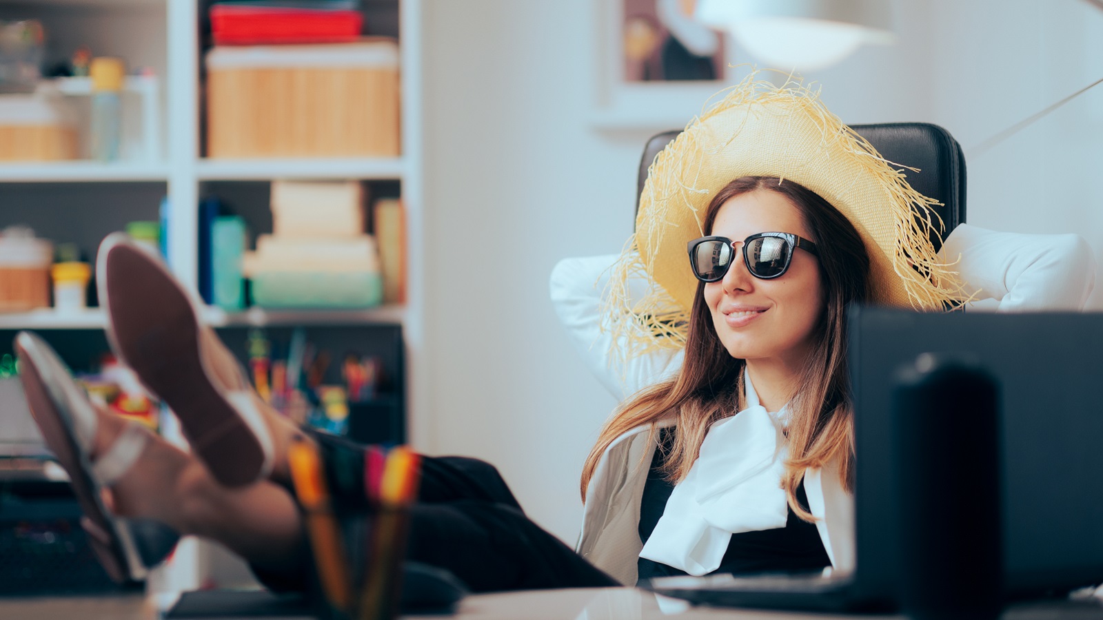 A woman procrastinates at her desk instead of working.