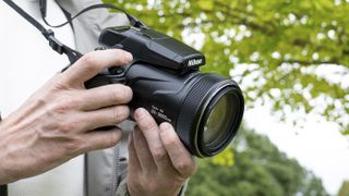 Nikon Coolpix P1100 superzoom camera in the hand