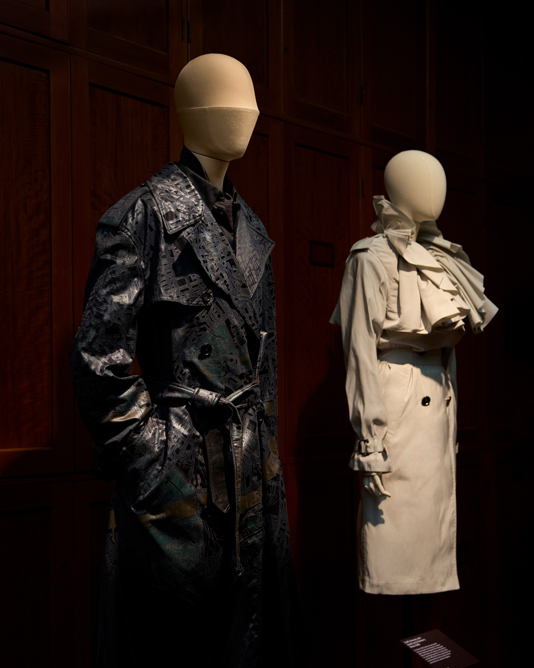 A pair of trench coats on display at Burberry V&amp;amp;A exhibition