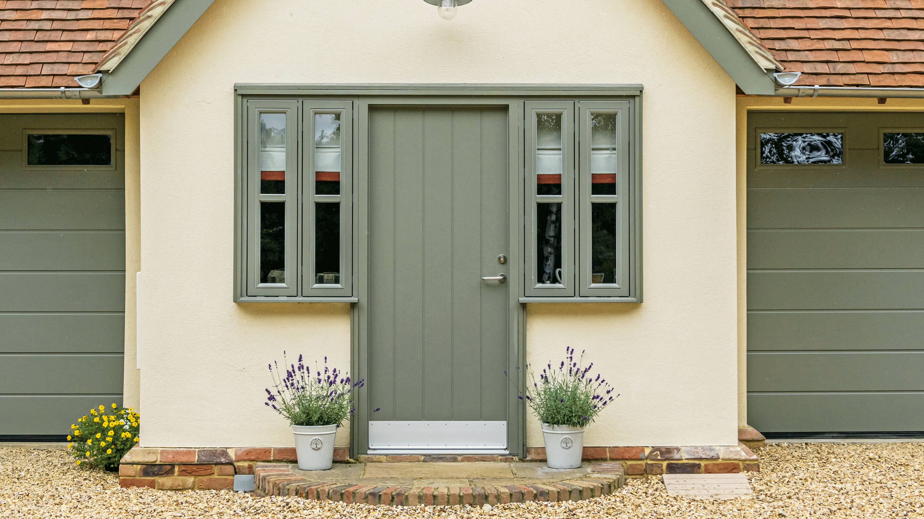 Yellow house with green trim and window frame