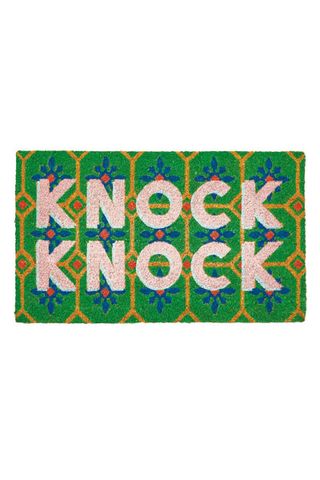 green doormat with knock knock motif