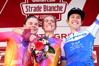 SIENA, ITALY - MARCH 04: (L-R) Lotte Kopecky of Belgium and Team SD Worx on second place, race winner Demi Vollering of The Netherlands and Team SD Worx and Kristen Faulkner of The United States and Team Jayco-Alula on third place pose on the podium ceremony after the Eroica - 9th Strade Bianche 2023, Women's a 136km one day race from Siena to Siena 318m / #StradeBianche / on March 04, 2023 in Siena, Italy. (Photo by Luc Claessen/Getty Images)