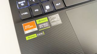 Asus ROG Flow X13 laptop stickers close up on a white desk
