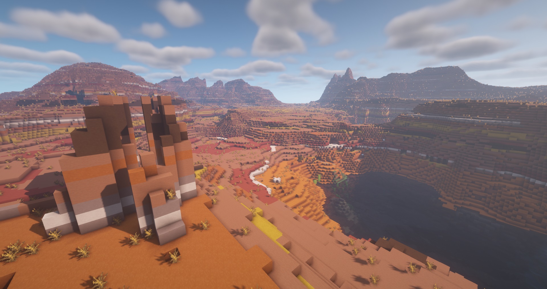 Minecraft - A very large Badlands biome full of skinny clay spikes and giant clay mountains in the background.