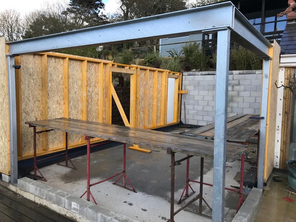 A ground floor room being constructed of steel framing with stick frame timber walls.
