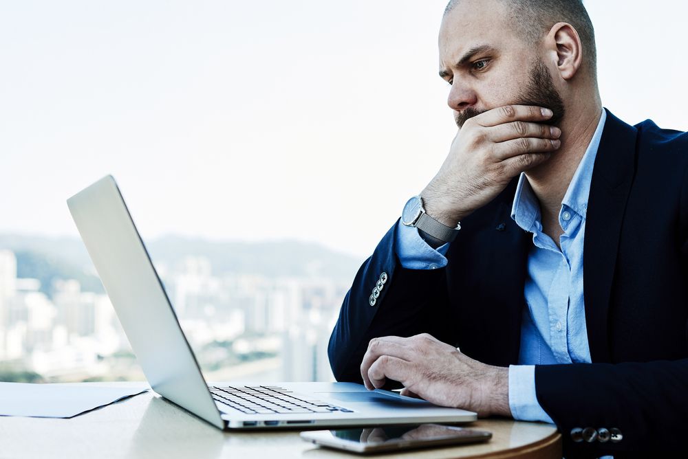 Man confused by laptop