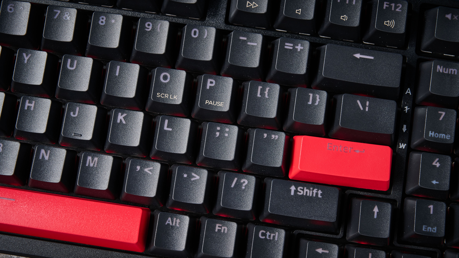 A black Lemokey X5 wired mechanical keyboard with red and black keycaps