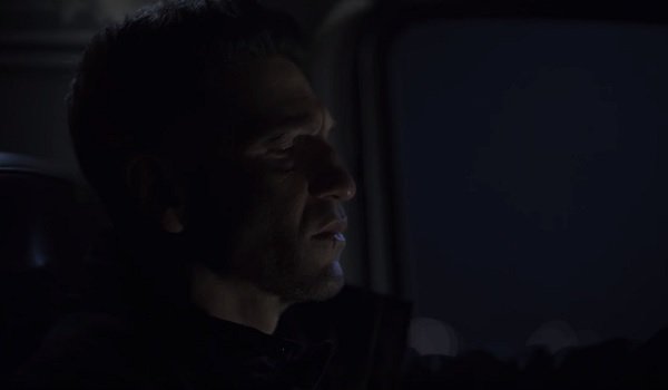 The Punisher sits in his car, scowling