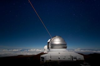 The Gemini North Observatory in Hawaii shoots a laser beam into the sky as an "artificial star."