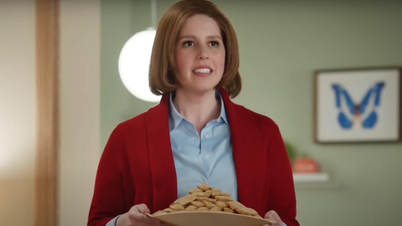Vanessa Bayer holding a plate of Pizza Rolls on SNL