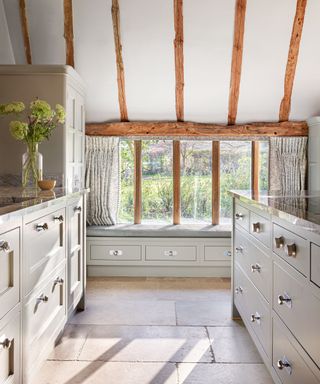 Cozy kitchen with cream walls and wood beamed ceiling