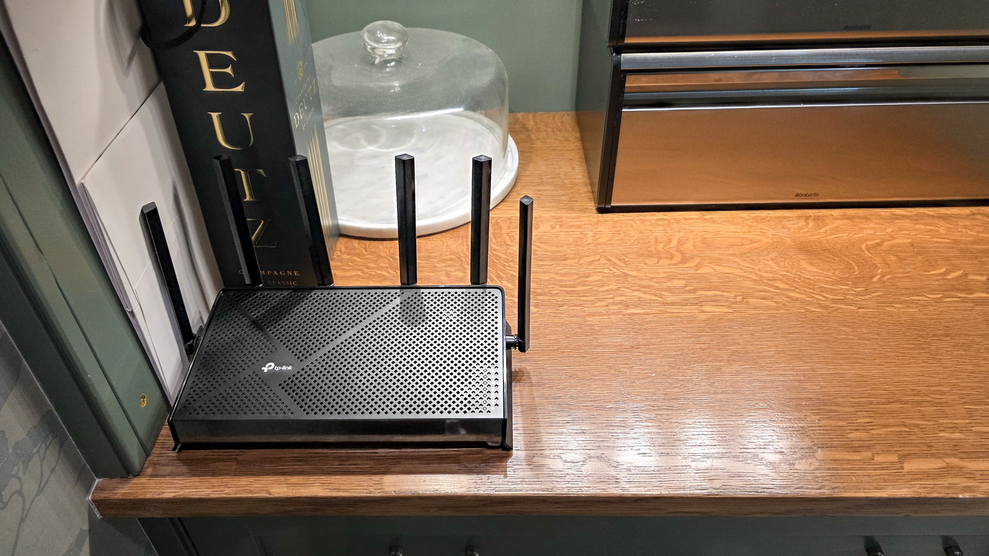 TP-Link Archer BE9700 router on shelf