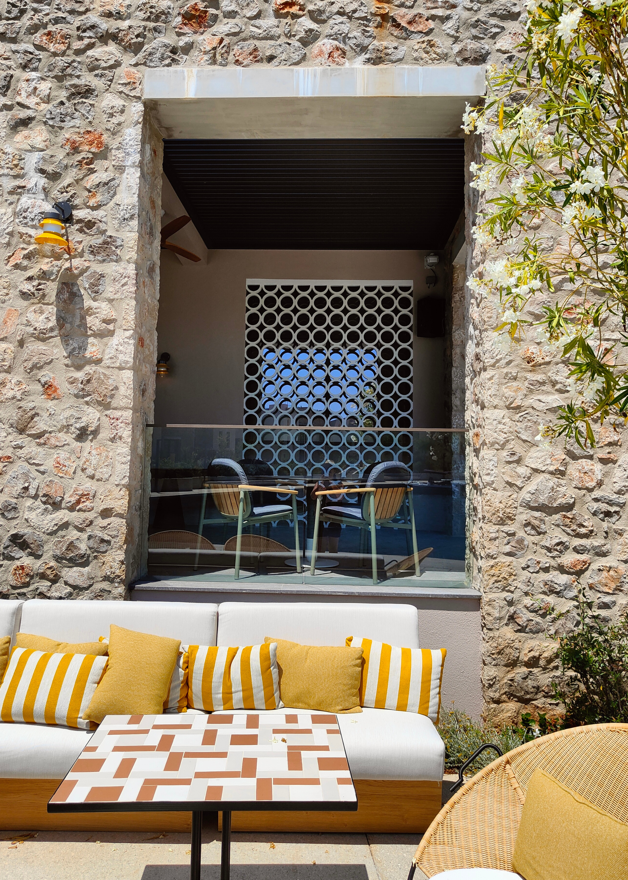 An outdoor dining space in a Greek garden