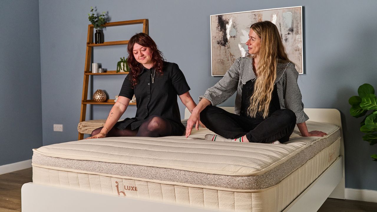 Two Tom's Guide testers sitting on the top of the Birch Luxe Natural smiling