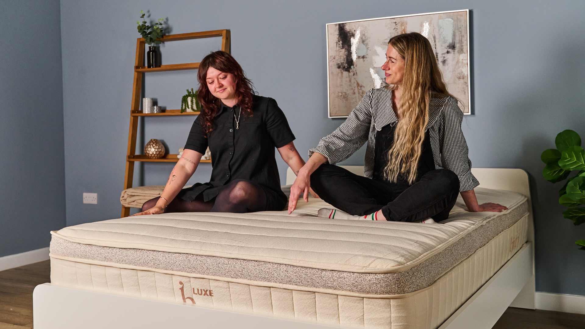 Two Tom's Guide testers sitting on the top of the Birch Luxe Natural smiling