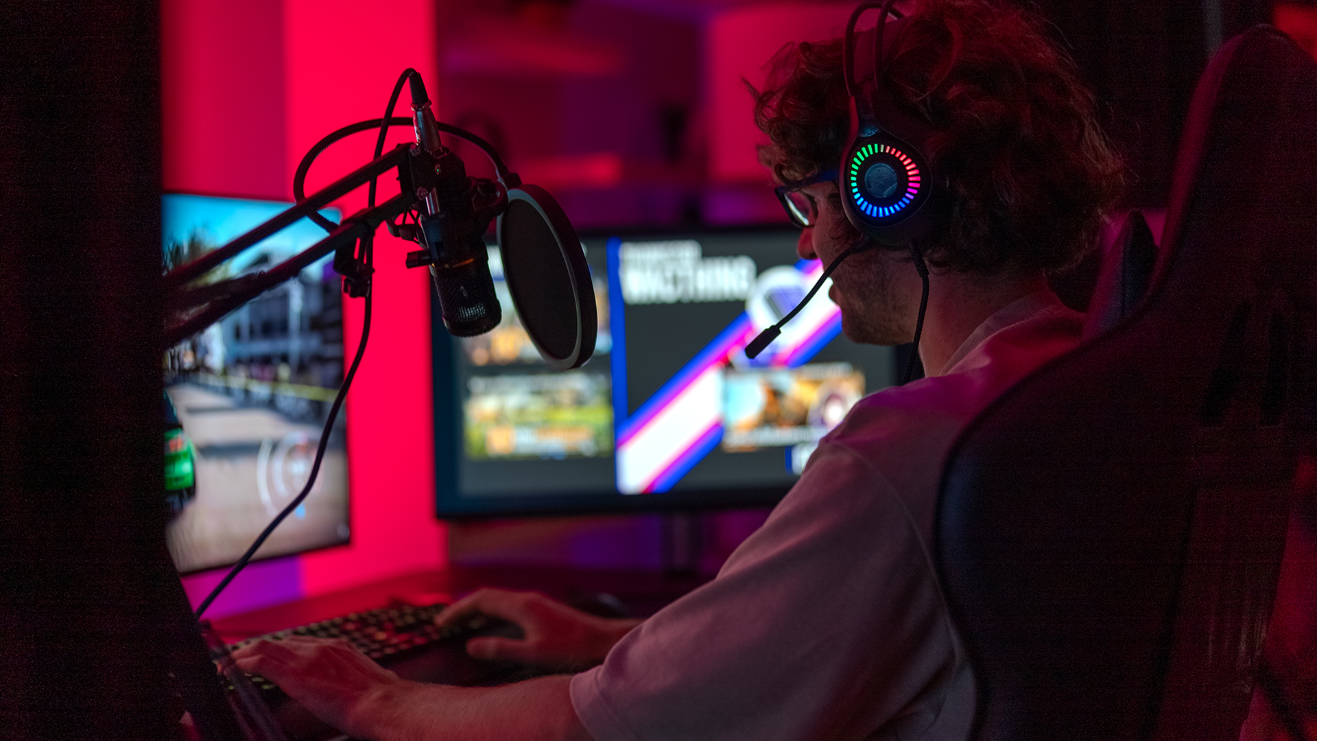 PC gaming in private room at home . Neon, computer and male gamer with headphones for playing.