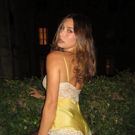 Hailey Bieber posing for a photo at Paris Fashion Week.