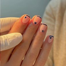 A navy French tip manicure