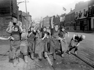 A policeman directs traffic from a metal bin, Harrow boys queue for sweets in straw boaters, and men on stilts tend the Kent hops: new photo book opens a fascinating window on 1930s Britain