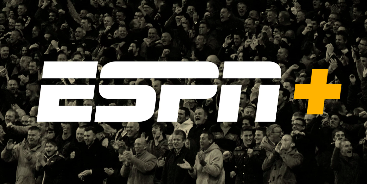 Logo ESPN + suspendu dans les airs au-dessus d'une foule de fans de sport en liesse