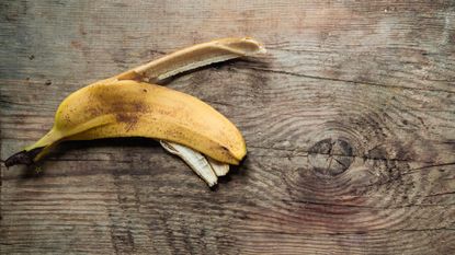 A banana peel on a wooden floor