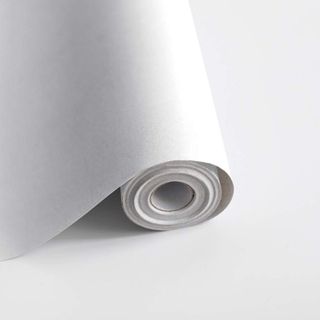 A white roll of peel-and-stick wallpaper