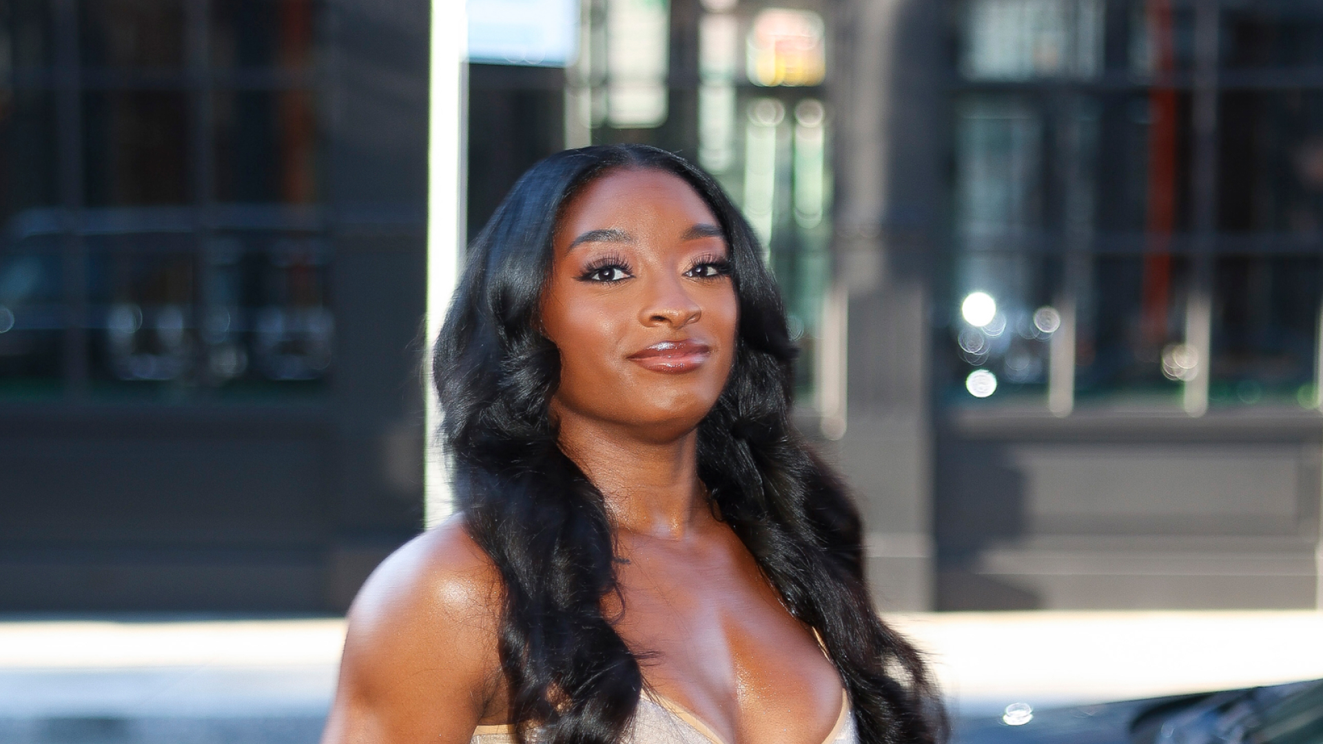 Simone Biles with long, curled hair