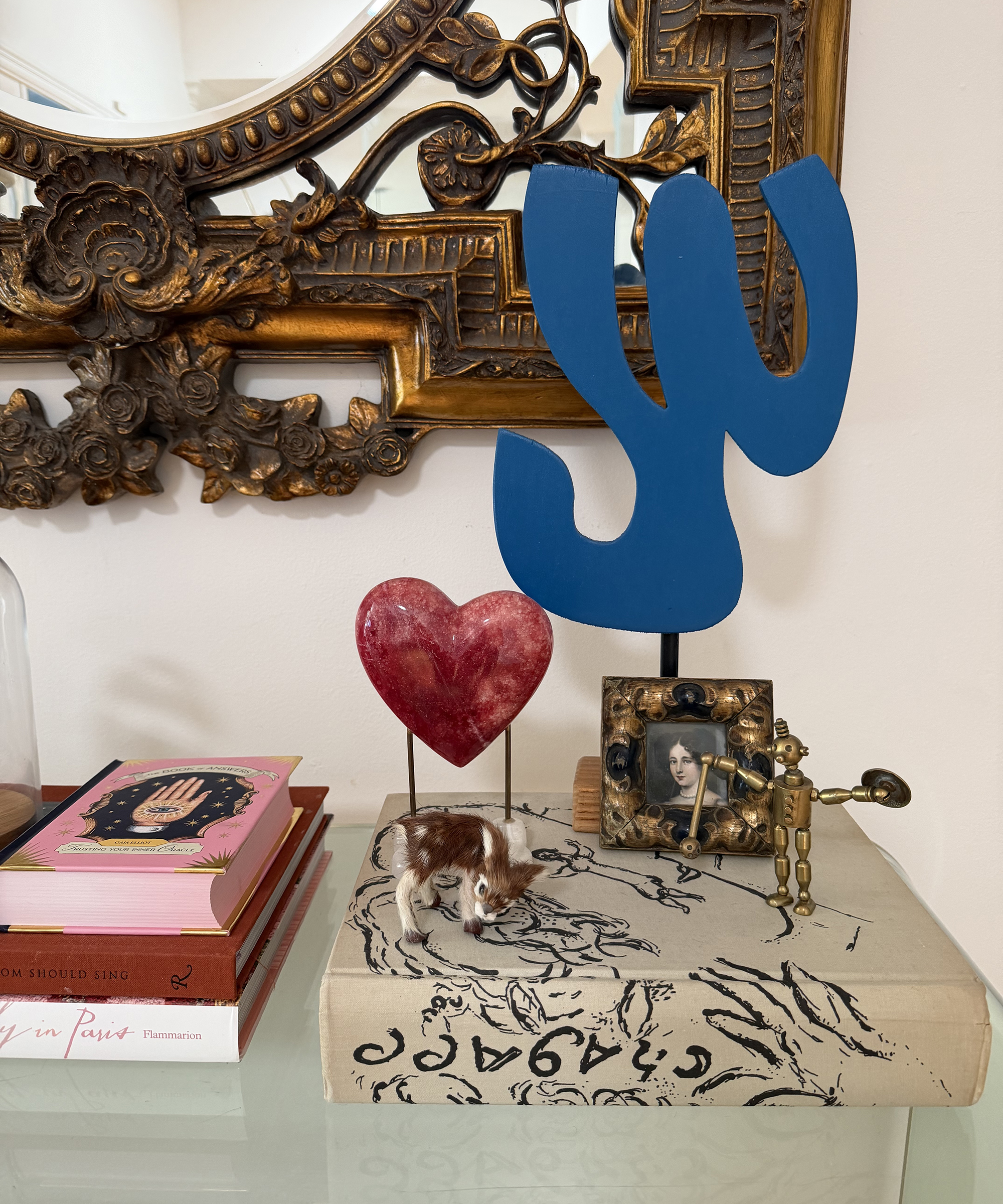shelf with display of books and sculptures