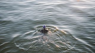 A woman swims in the open water