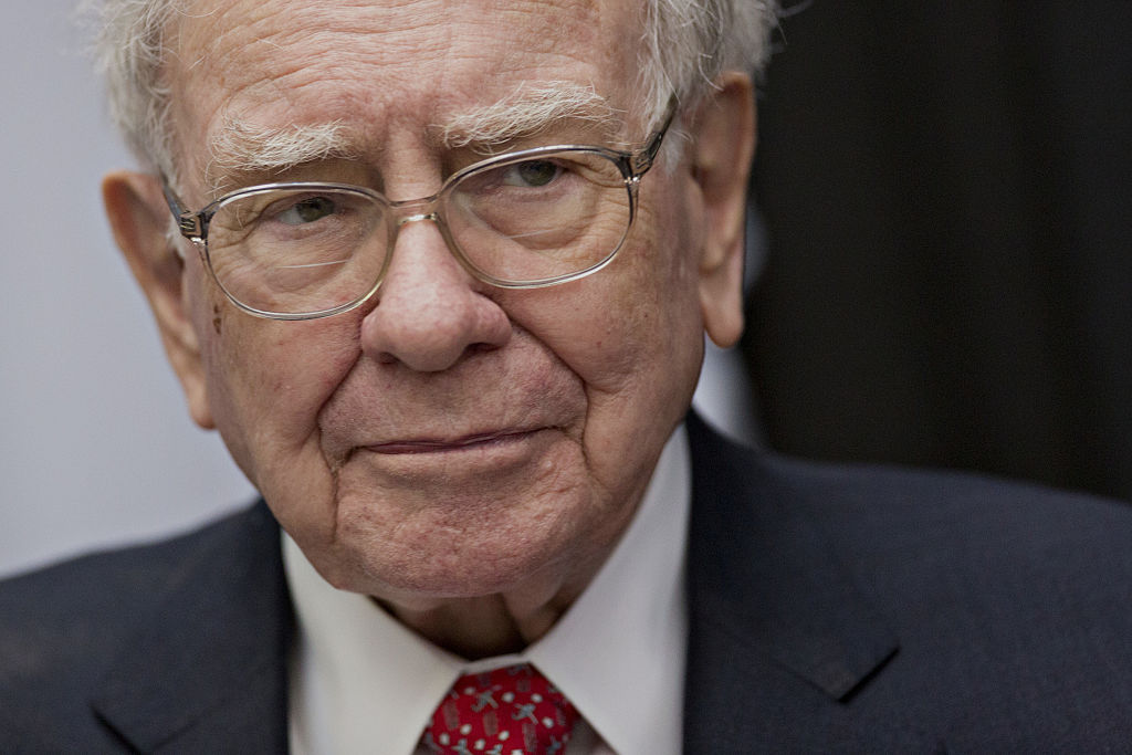 Warren Buffett, chairman and chief executive officer of Berkshire Hathaway Inc., listens while playing cards on the sidelines the Berkshire Hathaway annual shareholders meeting in Omaha, Nebraska, U.S., on Sunday, May 1, 2016. 