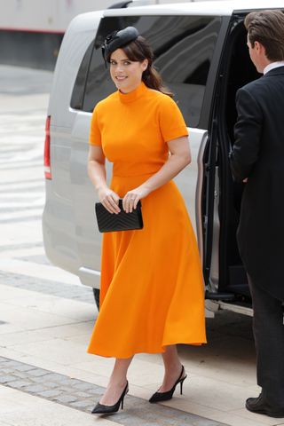 Princess Eugenie in a bright orange dress