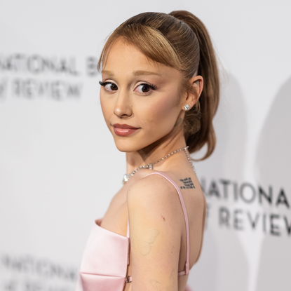 Ariana Grande attends the 2025 National Board of Review Gala at Cipriani 42nd Street on January 07, 2025 in New York City with ethan slater wearing a pink blackess dress and a beaded loewe squeeze bag