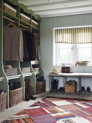 green painted boot room with rug