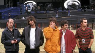 Photo of Alan WHITE and Paul Bonehead ARTHURS and Paul Guigsy McGUIGAN and Liam GALLAGHER and OASIS; Posed group shot backstage L-R Paul 'Bonehead' Arthurs, Liam Gallagher, Noel Gallagher, Paul 'Guigsy' McGuigan and Alan White