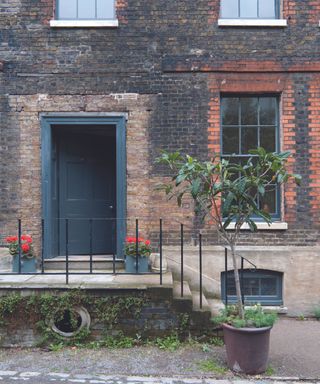 Dark gray door of a red brick building