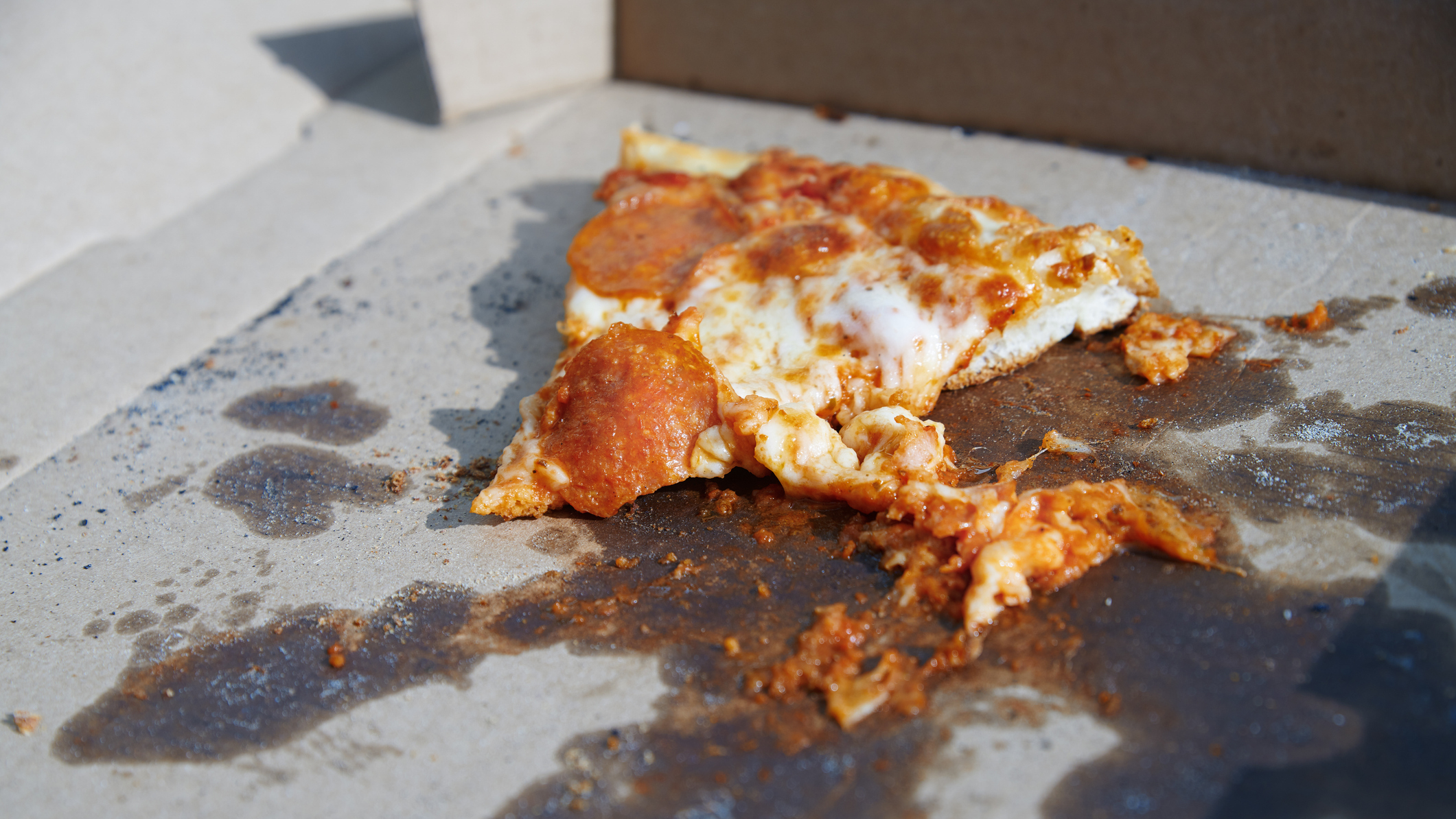 Pizza slice on cardboard